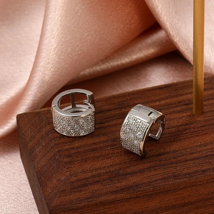 Macro detail of S925 sterling silver hoop earrings with shimmering white zircon stones