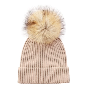 Detail of core-spun yarn knit hat with ribbed texture and large faux fur pom-pom