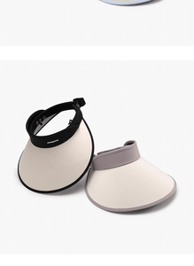 Detail of wide brim sun visors in black and beige, showing breathable ice silk fabric