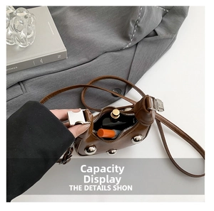 Internal view of brown leather crossbody bag showing capacity for lipstick and perfume