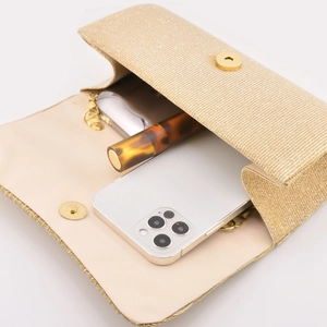 Golden pleated evening clutch bag with chain strap and interior showing storage capacity