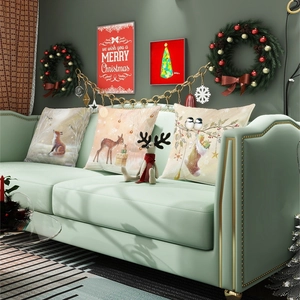 Christmas pillow covers with fox and deer patterns in a cozy festive living room setting