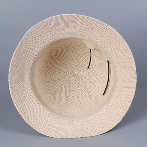 Detail of beige straw sun hat interior showing inner sweatband and adjustable drawstring