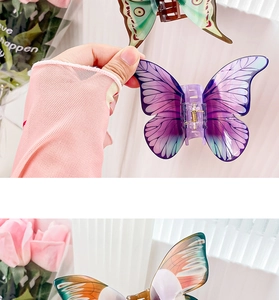Detailed close-up of translucent butterfly hair claw clips with gradient wing textures