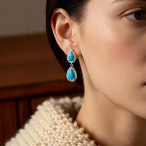 Vintage silver water drop earrings with turquoise stone and zircon on a model