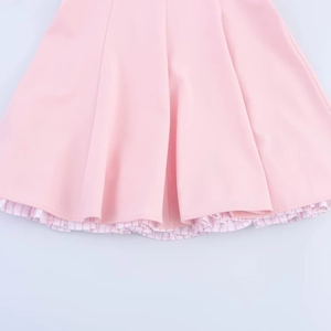 Pink mini dress with striped lining detail and layered hemline shown in flat lay view