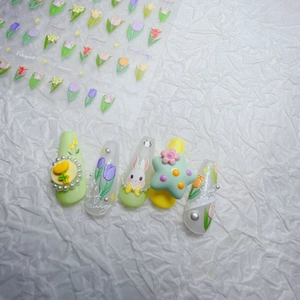 Detail of 3D embossed nail stickers featuring pink rabbits and tulip floral patterns