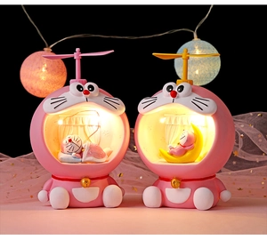 Pink sleeping character resin night lights with glowing spheres and soft mesh decor