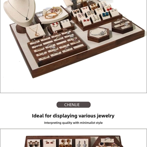 Detail of walnut wood jewelry display set with beige velvet lining for rings and necklaces