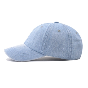 Side view of a vintage washed denim baseball cap in light blue with adjustable strap