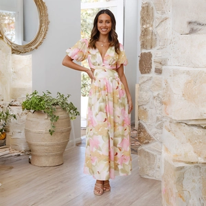 Detail of floral maxi dress with side cut-outs and puff sleeves in elegant summer style