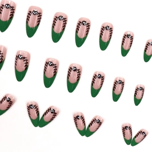 French tip almond press-on nails with green frosted finish and black skull designs