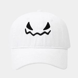 Close-up of black monster embroidery on white washed cotton baseball cap details