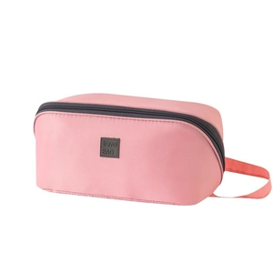 Pink portable travel organizer bag with handle and travel bag label on white background