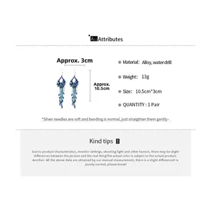 Detail view of long tassel earrings with blue water drill floral charms and alloy beads