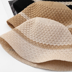 Close-up of hollow crochet knit texture on stylish striped bow fisherman bucket hats