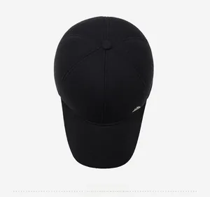 Top view of black winter wool baseball cap showing six-panel stitching and metal logo