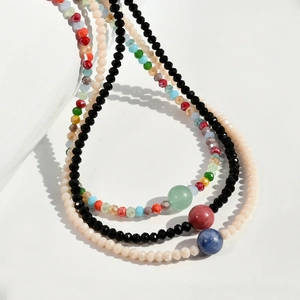 Detail of layered Y2K necklaces with natural agate beads and faceted crystals