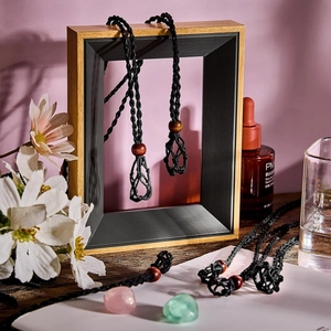 Handmade black woven crystal holder necklace with adjustable wooden bead on a frame