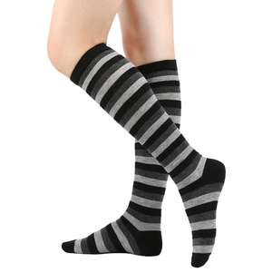 Detail showing the fit and length of black and grey striped over-the-knee socks on legs