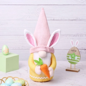 Easter gnome plush decoration with rabbit ears holding a carrot on wood background