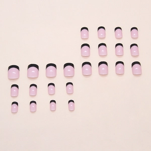 Minimalist French style press-on nails with natural pink base and chic black tips