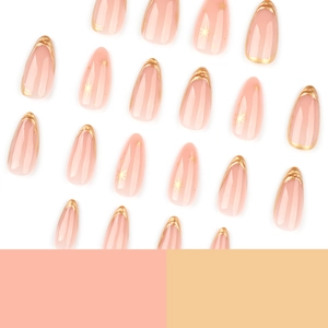 Short almond press on nails with nude pink base, gold french tips and star accents