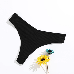 Detail of black ribbed cotton thong showing elastic fabric texture and minimalist design