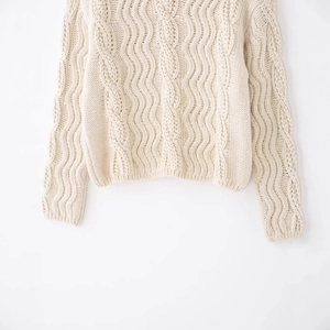 Classic cream cable-knit wool sweater featuring thick Fair Isle pattern and cozy texture