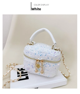 Close-up of white sequin girls crossbody bag with gold chain strap and metal details