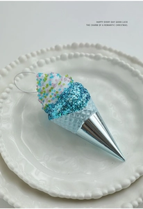 Detail view of blue glitter ice cream ornament with silver cone for Christmas tree decor