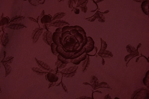 Detailed macro view of burgundy rose print fabric with elegant mesh texture finish