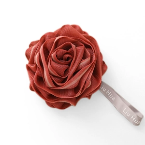 Deep red rose-shaped bath sponge made of layered nylon mesh with a grey hanging ribbon