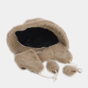 Detailed top view of beige plush winter bucket hat with earflaps and white faux fur pom-poms
