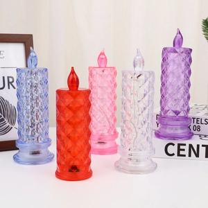 Detail view of colorful crystal rose LED candles with diamond cut texture and warm glow