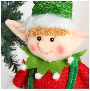 Close-up of a Christmas elf doll showing red and green knit textures and glittery hat details