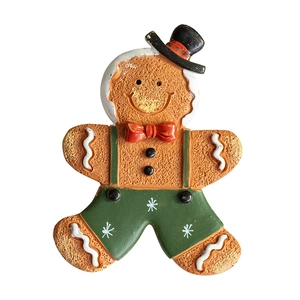 Hand-painted gingerbread man ornament with top hat and green pants on white background