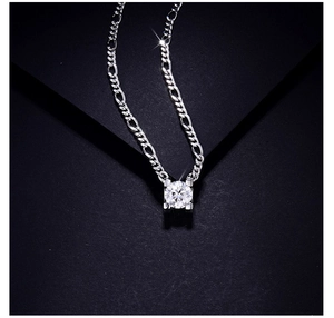 Close-up of sparkling 2ct round-cut moissanite pendant on silver sterling chain