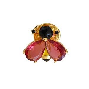 Vintage enamel bee brooch with red and black crystals on a gold-plated metal base