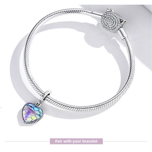 Macro detail of S925 sterling silver snake chain bracelet with iridescent heart charm
