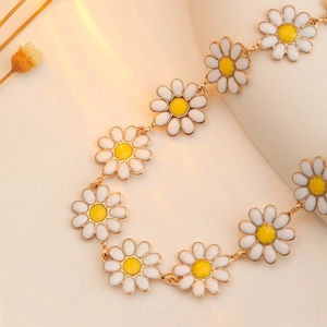 Close-up of sweet daisy floral bracelet with white enamel petals and gold links