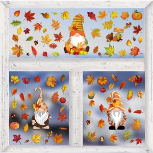 Close-up of autumn window clings with gnomes and maple leaves on a white frame