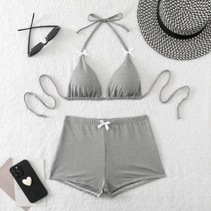 Houndstooth two-piece bikini set with high-waisted shorts and white bow details