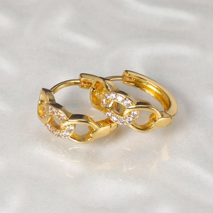 Close-up of gold-plated butterfly hoop earrings with white zircon chain-link texture