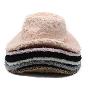 Detailed stack of plush cowboy hats in various colors showing soft lamb wool texture