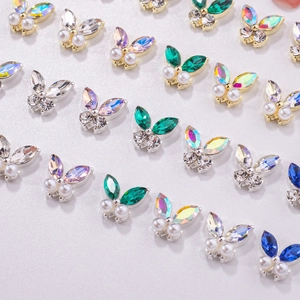 Macro shot of 3D alloy butterfly nail charms with colorful rhinestones and pearls