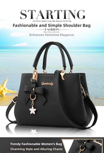 Detail of black lychee grain leather handbag with bow decoration and golden star pendant