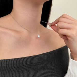 Macro view of minimalist S925 silver necklace featuring a sparkling rectangular zircon stone