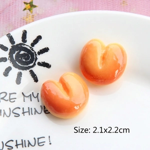 Close-up of 2.1x2.2cm heart-shaped resin biscuit charms with orange gradient finish