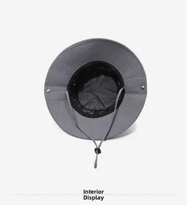 Detail of grey sun hat featuring breathable black mesh lining and adjustable chin strap